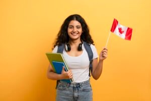 Happy student holding a Canadian flag